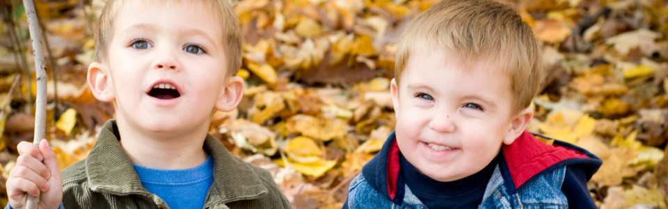 Two boys on a backdrop of leaves